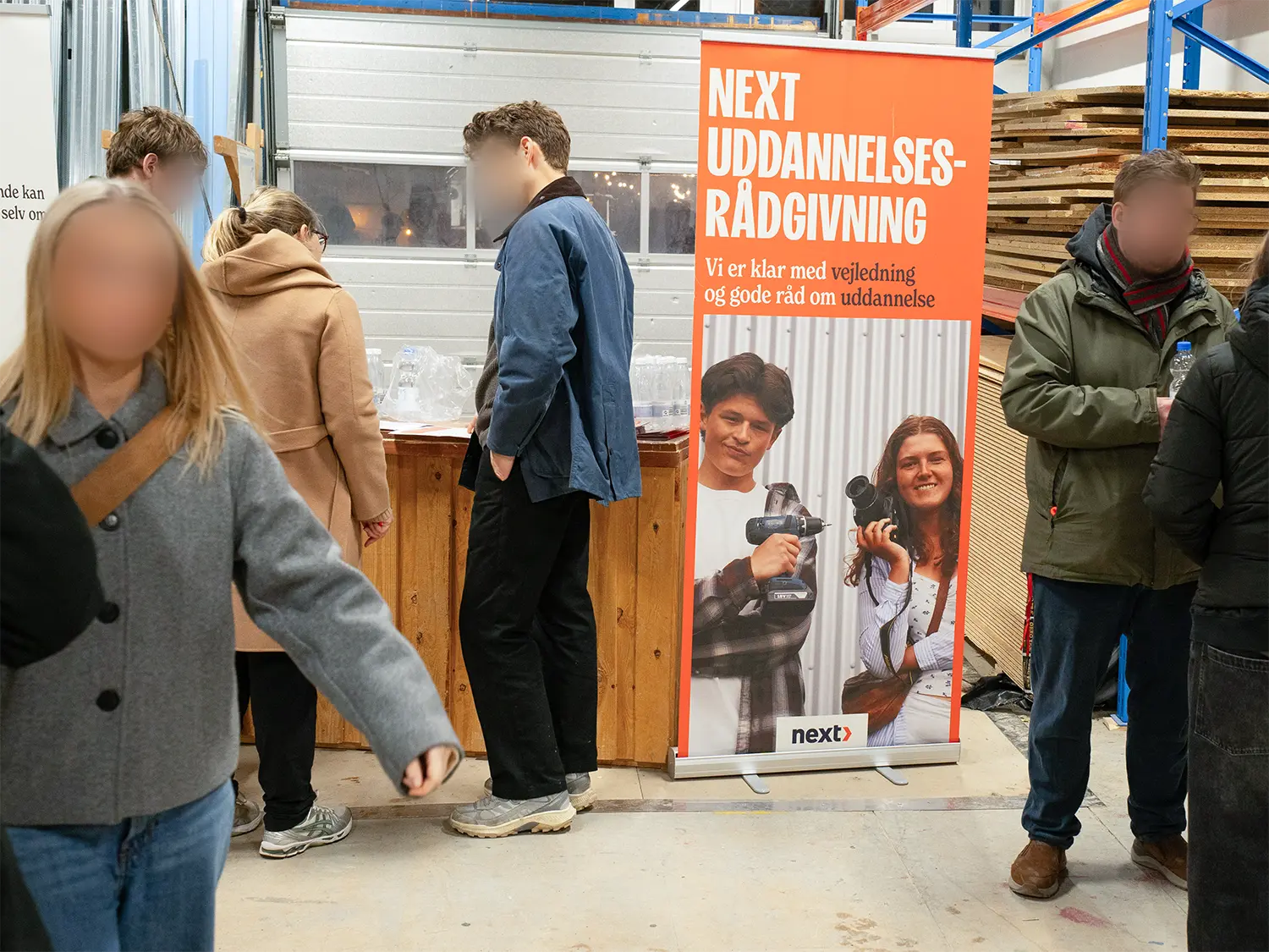 People surrounding the education roll-ups at the event